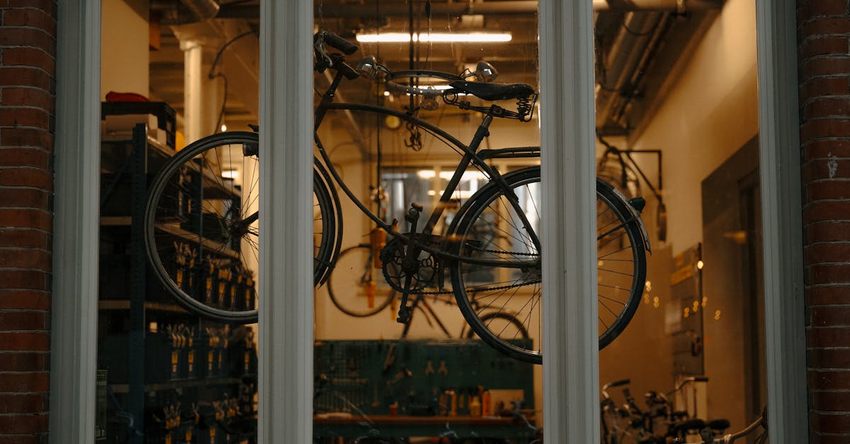 A vintage bicycle is displayed in a workshop window in Amsterdam, showcasing urban cycling culture.